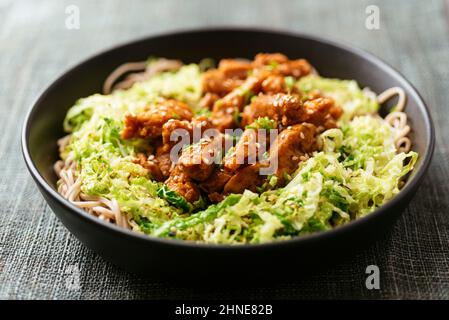 Spicy soy curls on shredded savoy cabbage, served with buckwheat noodles.