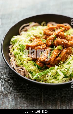 Spicy soy curls on shredded savoy cabbage, served with buckwheat noodles.