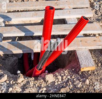 Exit point of underground electrical communications at a construction site Stock Photo
