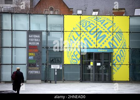 A man walks outside the entrance of the National Football Museum in Manchester City centre, England, UK. Stock Photo