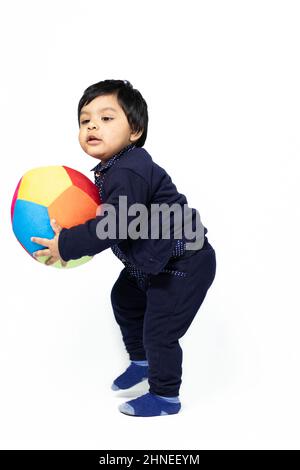 Cute Asian Indian Infant Boy Playing With Colorful Big Ball. Fun, Activity, Educational, Kindergarten, Birthday, Learning, Home Activity, School, Nurs Stock Photo