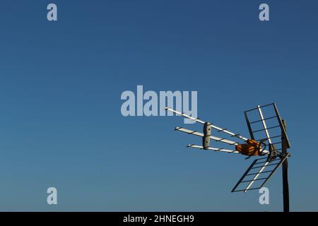 Rooftop TV antenna against a clear blue sky Stock Photo
