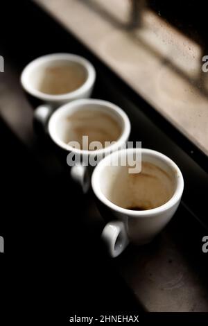 used coffee cups on a windowsill. Winter tones. Stock Photo