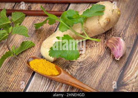 fresh ground ginger on a wooden background Stock Photo