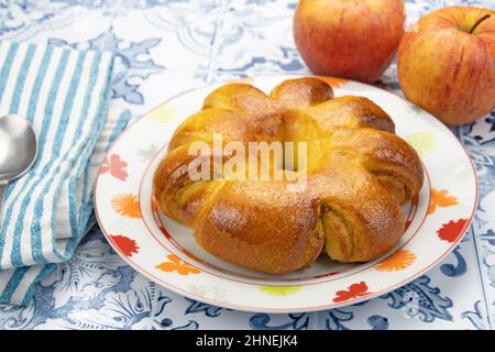 brioche in a plate with apples on a table Stock Photo