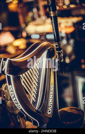 Bucharest, Romania - December 3, 2021: Illustrative editorial image of a Guinness beer tap displayed in a pub in Bucharest, Romania. Stock Photo