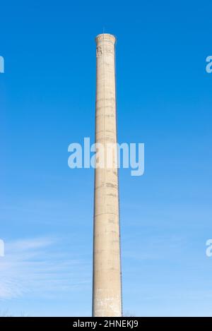 Old smoke stack with blue skies in the background. Stock Photo