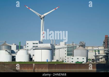 Industrial plant and wind turbine in the Port Kanalhafen of Magdeburg on the river Elbe Stock Photo