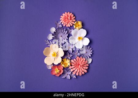 Floral Easter background with egg shape design. Paper art and handcraft. Trendy very peri color. Flower pattern Stock Photo