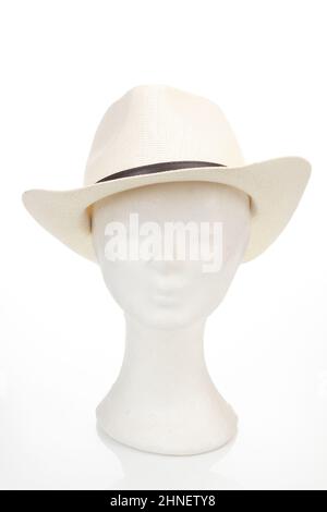 Mannequin head wearing straw hat isolated on white background, front headshot Stock Photo