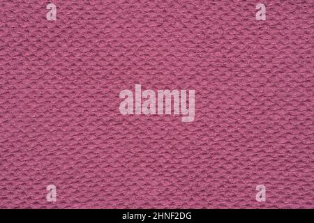 Texture of pink waffle towel. Background of natural waffled cloth from organic linen and cotton. Stock Photo