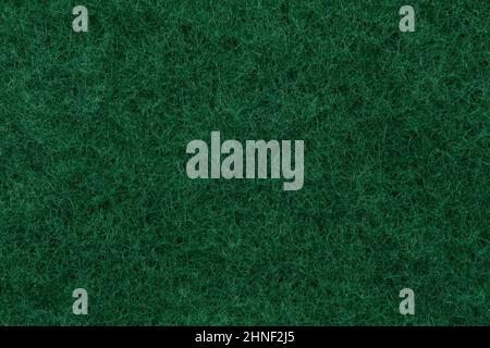Texture of a abrasive scourer dishwashing sponge. Background of a scrub sponge close up. Stock Photo