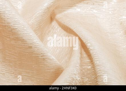 White fabric. The texture of the material, chintz or satin in a light shade with folds and waves. Cloth Stock Photo