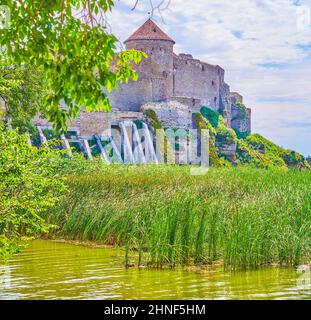 The reeds of Dniester river bank and the medieval Akkerman Fortress on background, Bilhorod-Dnistrovskyi, Ukraine Stock Photo