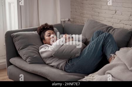 Young devastated depressed African American woman crying feeling sad, hurt suffering depression sadness and emotional pain. Mental health in young Stock Photo