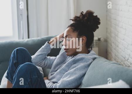 Young devastated depressed African American woman crying feeling sad, hurt suffering depression sadness and emotional pain. Mental health in young Stock Photo