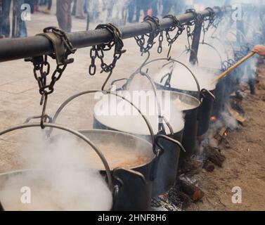 Cooking in iron cauldrons on open fire Stock Photo