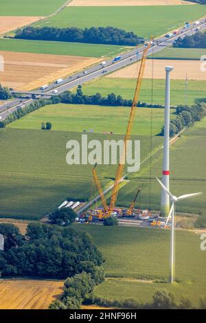 Aerial view of wind turbine construction site featuring a tall crane ...