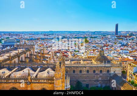 Giralda tower of Seville Cathedral is a perfect viewpoint, observing stunning Gothic Cathedral's roof and Casco Antiguo district buildings, Seville, S Stock Photo