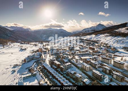 Aerial view of Sestriere village from above, famous ski resort in the italian western Alps, Piedmont, Italy. Sestriere, Italy - February, 2022 Stock Photo