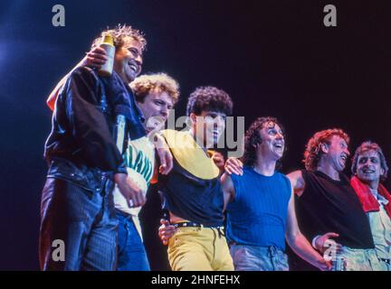 Mick Jones, Lou Gramm, Mark Rivera, Dennis Elliott, Rick Wills and Bob Mayo of Anglo-American band Foreigner taking a bow at the end of a concert at Wembley Arena, London, in 1982. Stock Photo