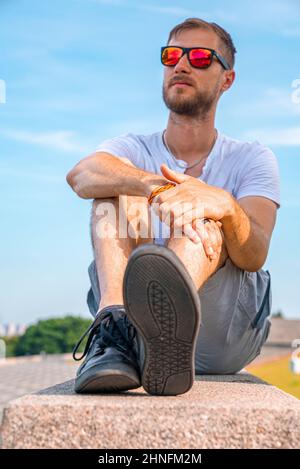 Sunny portrait of thoughtful handsome man admiring something interesting Stock Photo