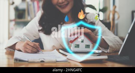A woman holding and checking house model .Real Estate House Appraisal And Inspection and Insurance concept. Stock Photo