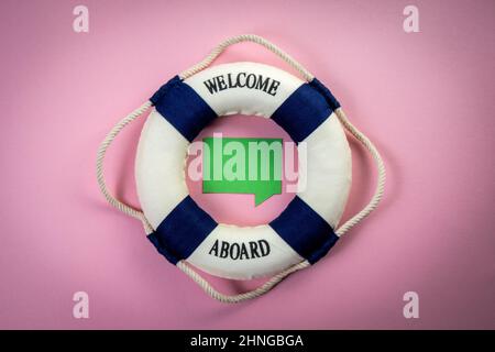 Miniature lifebuoy with an inscription and a green speech bubble in the center. Copy space. Stock Photo