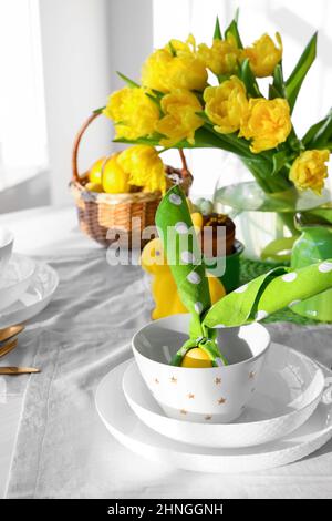 Stylish setting for Easter celebration on dining table Stock Photo