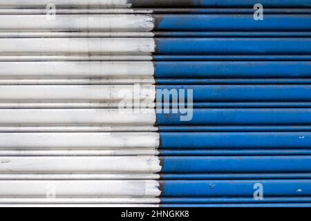 Background of blue and white colored metal curtain door. Stock Photo