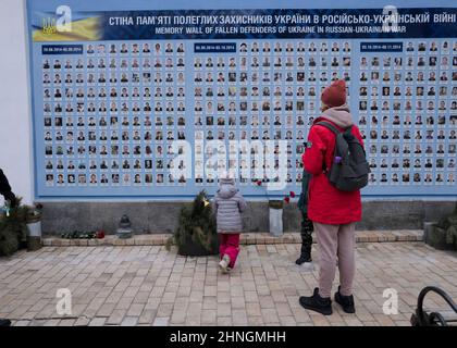 A mother and her children stand in front of the Memorial wall to fallen soldiers in the war between Ukraine and Russia, in Kiev, Ukraine, on February 16, 2022. Russian forces massed along Ukraine's borders have increased by approximately 7,000 troops in recent days, the United States alleged Wednesday evening, despite claims from Moscow it was pulling back. Photo by Rafael Yaghobzadeh/ABACAPRESS.COM Stock Photo