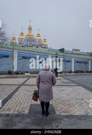 A women stands with flowers in front of the Memorial wall to fallen soldiers in the war between Ukraine and Russia, in Kiev, Ukraine, on February 16, 2022. Russian forces massed along Ukraine's borders have increased by approximately 7,000 troops in recent days, the United States alleged Wednesday evening, despite claims from Moscow it was pulling back. Photo by Rafael Yaghobzadeh/ABACAPRESS.COM Stock Photo