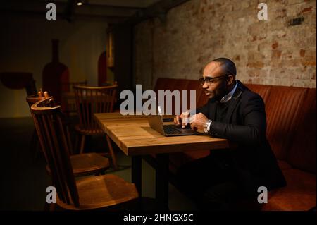 An African-American business man in a business suit is talking on a video conference. Video conference with partners Stock Photo