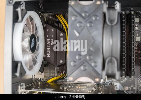 The contents of a desktop computer. The system unit of a modern computer with the side cover removed. Ukraine, Nikolaev - 02 09 2022. Stock Photo