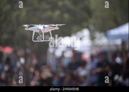 Drone flying in an outdoor event with bokeh lights Stock Photo