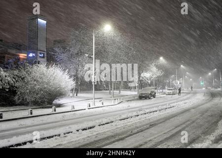 Snow cityscape of a street in Istanbul Turkey with a blizzard.Winter snowstorm 2022 in Istanbul. A snow-covered road with people and cars in a storm. Stock Photo