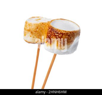 Grilled marshmallows on sticks isolated on white Stock Photo