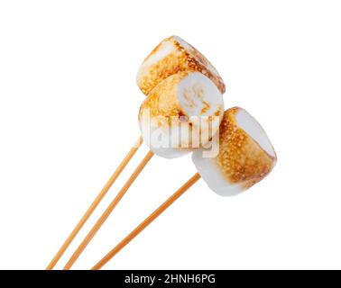 Grilled marshmallows on sticks isolated on white Stock Photo