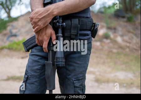 Cropped shot of man standing with weapon Stock Photo