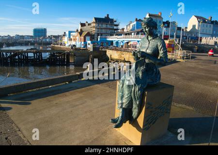 The bronze statue of  Gansey Girl overlooks the Harbour at Bridlington seaside resort  in the East Riding of Yorkshire. Stock Photo