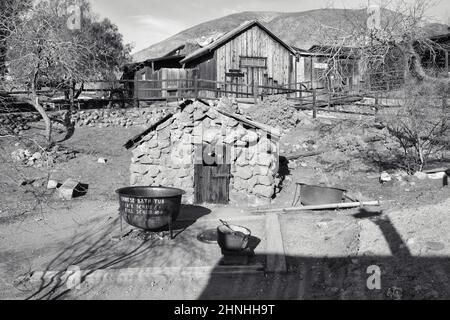 Black and white photo of the old Chinese bathhouse and an iron bathtub in the Wild West ghost town of Calico, San Bernardino County, California, USA Stock Photo