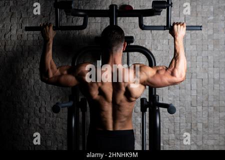 Male Athlete Doing Pull Ups Stock Photo