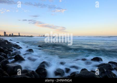 A view over the rocks of Burleigh Heads looking towards Surfers Paradise. Stock Photo