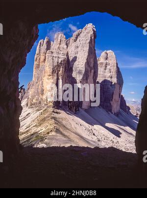 The image is of the famous Three Towers, known in German as Drei Zinnen but more poetically named in Italian as the Tre Cime di Laverado located in the Sexten-Sesto eastern region of the Italian Dolomites. During the First World War, known as the White War the peaks provided a natural barrier between the  Italians and the warring Austrians, the front line running through the peaks as seen from a Austrian machine gun observation window- position on the Paternkofel-Monte Paterno Stock Photo