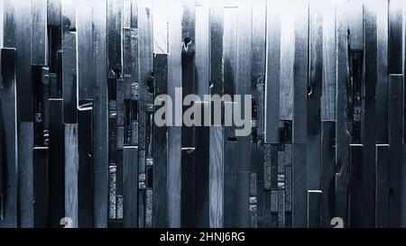 Illuminated decorative wall made of wooden boards in monochrome shades. Stock Photo