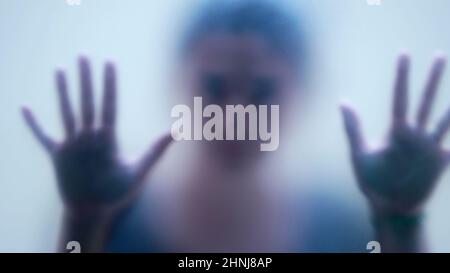 Woman behind matte glass blurry hand and body depression concept Stock Photo