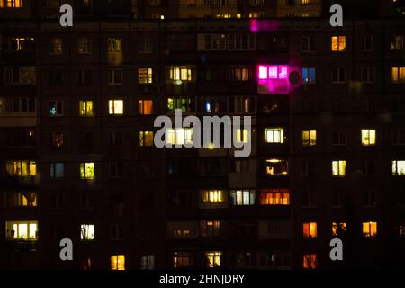Living apartment building windows at night - facade view Stock Photo