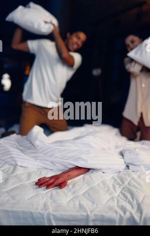 Couple attack bloody hand in bed with pillow Stock Photo