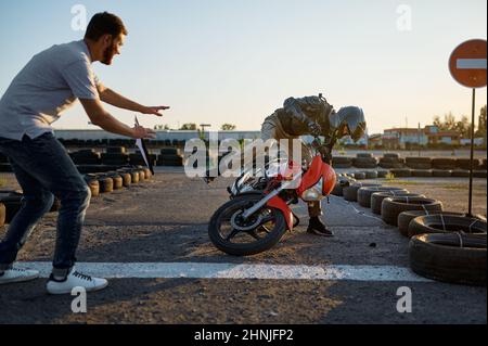 Student falls off a motorbike, motorcycle school Stock Photo