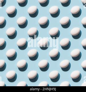 Organic white eggs on blue background. Abstract pattern. Eggs in isometric. Stock Photo